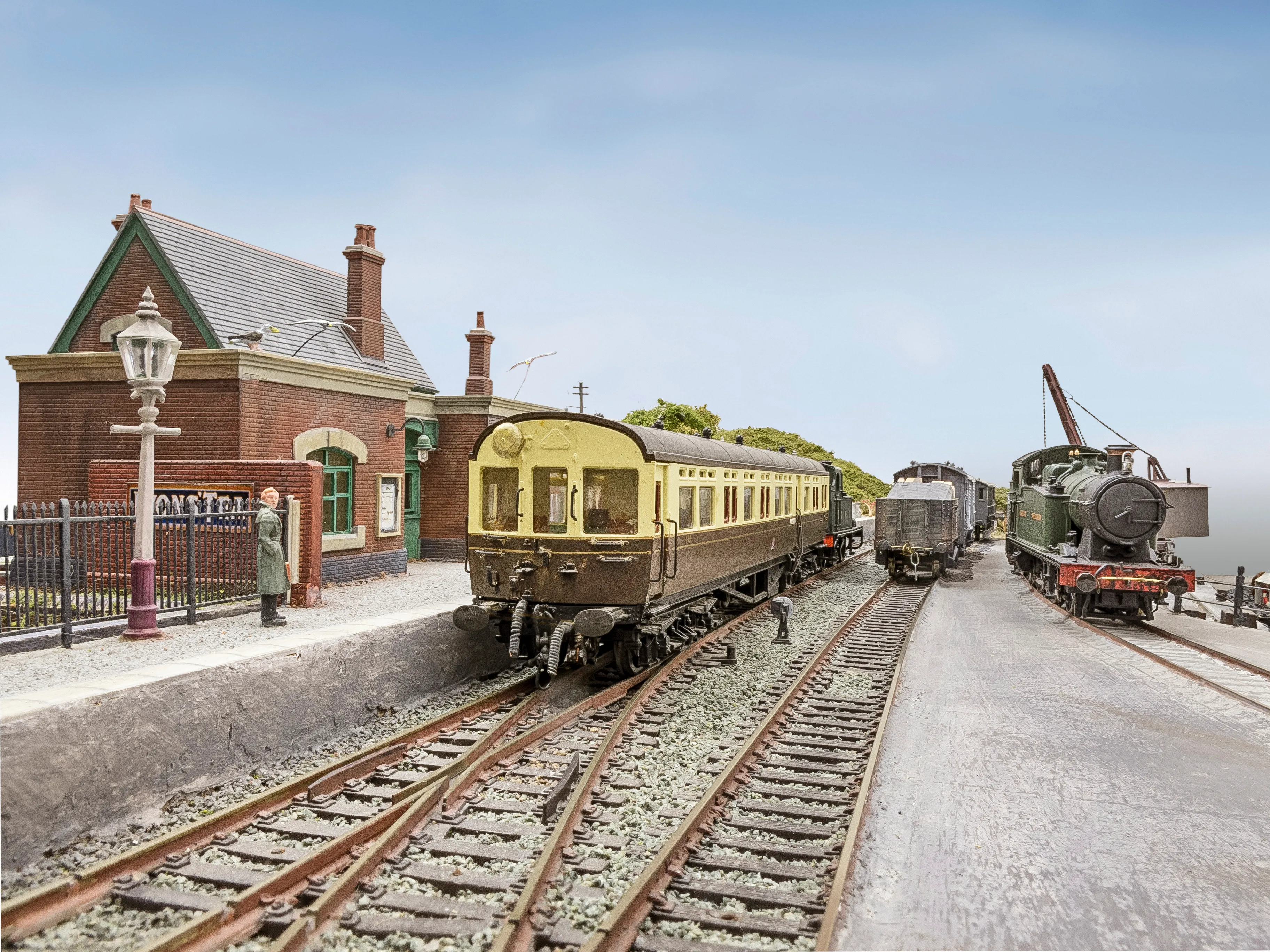 Two passenger trains and a freight train waiting at Bishop's Quay station platform